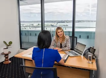 Clients working in a fully equipped office environment with great views in Servcorp 139 Quay Street, Auckland